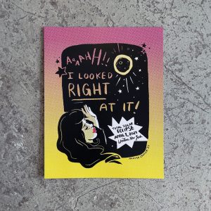 Wall art print black and white printed on pink and yellow halftone. Featuring damsel in distress and reads Ahh! I looked right at it! TOTAL SOLAR ECLIPSE APRIL 8, 2024 Western New York"