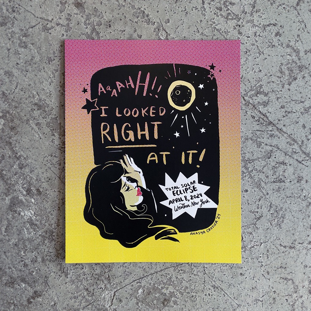 Wall art print black and white printed on pink and yellow halftone. Featuring damsel in distress and reads Ahh! I looked right at it! TOTAL SOLAR ECLIPSE APRIL 8, 2024 Western New York"