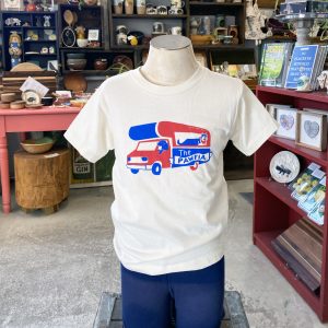 Buffalo Bills inspired shirt with the dog version of BILLS MAFIA. Toddler shirt features blue and red illustrations of dogs driving a Bills party bus. Text across the bus reads "The Pawfia". Short Sleeve t-shirt is white.