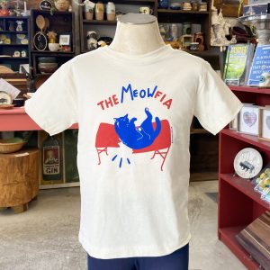 Buffalo Bills inspired shirt with the cat version of BILLS MAFIA. Toddler shirt features blue and red illustrations of a cat jumping through a table. Text across the top reads "The Meowfia". Short Sleeve t-shirt is white.