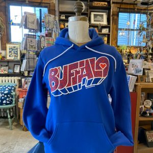 Royal Blue hoodie with red and white buffalo football team lettering printed on the front. On a mannequin inside a Made in Buffalo NY Gift shop